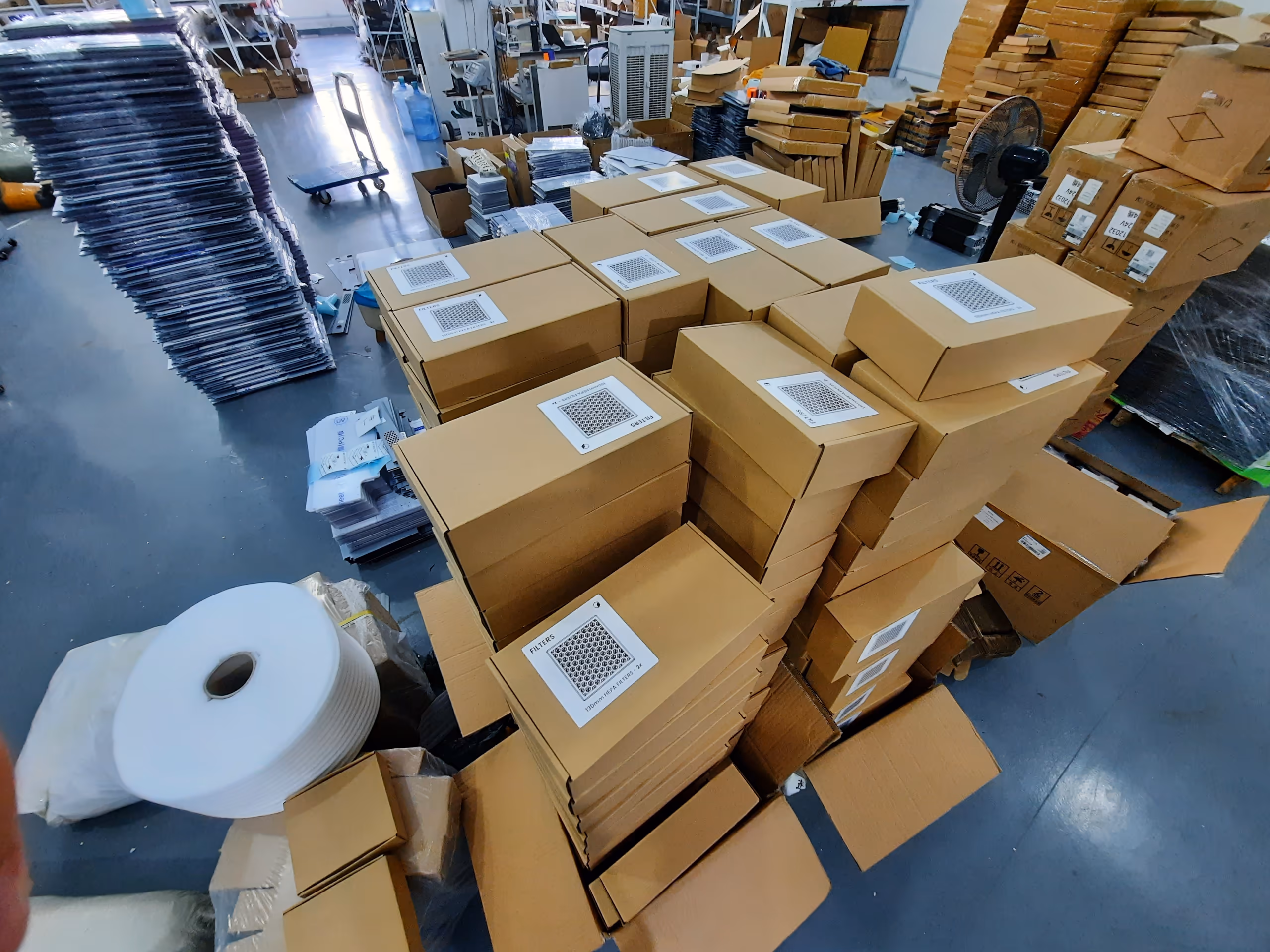 Pallets of flat-packed Clura enclosures ready to ship