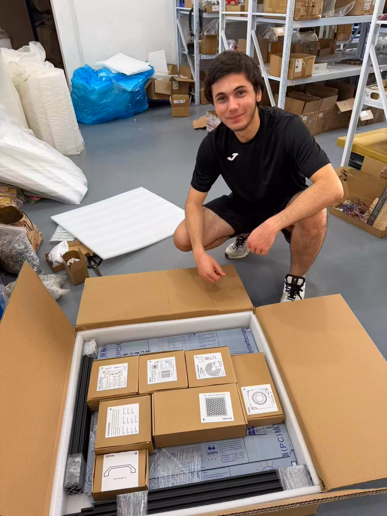 Fabrizio on the factory floor surrounded by finished stock